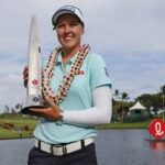 brooke henderson posing with trophy after winning at the Ko Olina Golf Club
