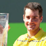john isner posing with trophy after winning the miami open