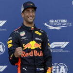daniel ricciardo celebrates on the podium after winning the monaco grand prix