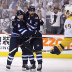 jacob trouba celebrates with blake wheeler after scoring against the nashville predators during second period action in winnipeg
