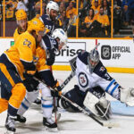 nashville predators battling it out in front of winnipeg jets net