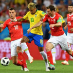 brazil's neymar da silva santos fights to retain possion of the ball in match against switzerland