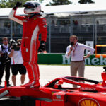 sebastian vettel waving to fans after winning pole position