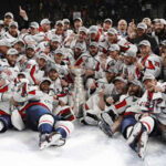 washington capitals posing to team photo with the stanley cup after defeating the golden knights in game 5