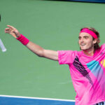 Stefanos Tsitsipas tosses his racket in celebration after defeating Novak Djokovic in round three of the rogers cup