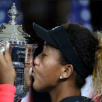 Naomi Osaka kisses the us. open womens trohy after defeating serena williams in two sets on Saturday