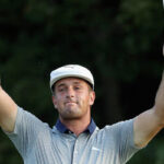 bryson dechambeau raises his firsts in celebration after winning the Dell Technologies Championship