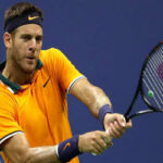 juan martin del potro returns serve against john isner on his way to winning and advancing to the u.s. open semifinals