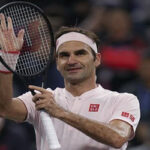 roger federer taps his racket towards the crowd after beating daniil medvedev to advance to the next round in shanghai