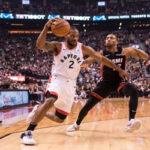 Kawhi Leonard of the toronto raptors moves past Rodney McGruder of the miami heat during the first half on sunday as the raptors came away 125-115 to earn the win