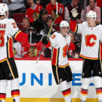 calgary flames celebrate after scoring two power play goals and defeating the chicago blackhawks 3-2 to lead the pacific division