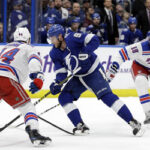 steven Stamkos engages new york islanders marc staal and neal pionk on his way to scoring a hat trick last night in tampa