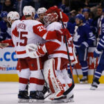 the detroit red wings congratulate goalie jonathan bernier after defeating the maple leafs 5-4 in overtime
