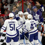 toronto maple leafs celebrate after defeating the carolina hurricanes 4- last night to end two game losing streak