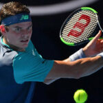Milos Raonic returns the ball during his match against Alexander Zverev during their match at the australian open.