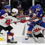 anders Lee of the New York Islanders scores in the first period after deflecting the puck last night against the new jersey devils