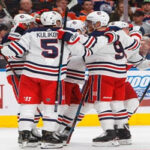 dmitri kulikov joins teammates celebrating after scoring against the oilers in edmonton last night.