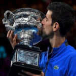 serbia's novak djokovic kisses the australian open trophy after defeating rafael nadal in the men's final on sunday in melbourne, australia