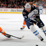 winnipeg captain blake wheeler rushes into the bruins zone as boston's sean couturier gives chase last night in boston
