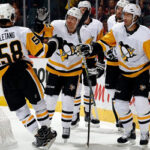 kris letang of the calgary flames is congratulated by teammates after scoring during the second period last night against the pittsburgh penguins