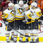 sidney crosby of the pittsburgh penguins congratulates teammates after defeating the edmonton oilers 3-1 last night in pittsburgh