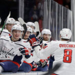 alex ovechkin celebrates with teammates after scoring against New York Islanders on Friday in Uniondale, N.Y.