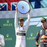Valterri Bottas raises his trophy on the podium after winning the australian grand prix in melbourne, australia