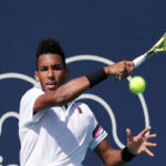 felix auger-aliassime returns volley during his match against nikolas basilashvili in the fourth round of the miami open