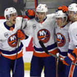 mathew barzal, michael dal colle and adam pelech celebrate with Anthony Beauvillier of the New York Islanders after Beauvillier scores against the Sens