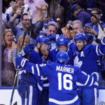 Mitch Marner celebrates with John Tavares after winning game 3 in their series against the Boston Bruins in Toronto on Monday nigh