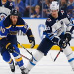 ryan o'reilly charges into the winning pegs jet's zone while being chased by winnippeg'smark scheifele