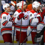 the carolina hurricanes congratulate goalie petr mrazak after winning defeating the new york islanders and going up 2-0 in the series