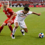 TFC's Jacob Shaffelburg scuffles with Atalanta United’s Marky Delgado for control of the ball on Wednsday at BMO Field