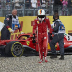 sebastian vettel walks away from his car after going into the gravel during last years german grand prix