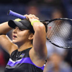 bianca andreescu raises her racket over her head after winning the semifinal match on thursday in new york.