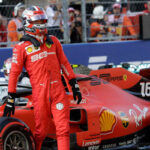 charles leclerc stands by his car after eanring pole position for sunday's russian gran prix at the sochi autodrome.