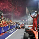 sebastian vettel raises his firsts in celebration atop his car after winning the singapore grand prix on sunday