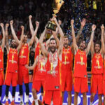 spain's rudy fernandez hoists the naismith trophy while posing with teammates on sunday after defeating argentina at the world basketball championships