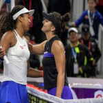 bianca andreescu congratulates naomi osaka on friday after the japanese player defeated the canadian to advance to the china open semifinals on saturday.