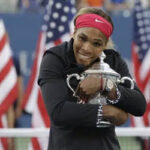 serena williams clutches her trophy after being awarded with the ap female athlete of the decade award.