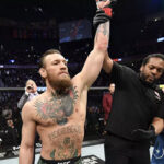 referee herb dean raises the arm of conor mcgregor after his 40 second defeat over donald cerrone in ufc 246's main event