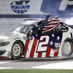 Brad Keselowski celebrates along the front stretch after winning the Coca Cola 600 on Monday.