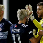 new englands kelyn rowe and dejuan jones congratuLate goalkeeper matt turner on sunday after defeating the montreal impact 1-0.