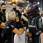 lewis hamilton celebrates with members of team mercedes after earning pole for sunday's bahrain grand prix.