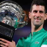 novak djokovic smiles while posing with his trophy after defeating daniil medvedev in the sustralian open finals on sunday at melbourne park.