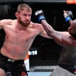 Jan Blachowicz lands a blow against Israel Adesanya at UFC 259