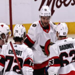Thomas Chabot and Artem Anisimov congratulate teammate Evgenii Dadonov after he helped lead the Sens to a 6-3 victory over the Montreal Canadiens on Saturday night.